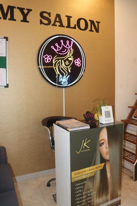 The neon My Salon crest above the front desk